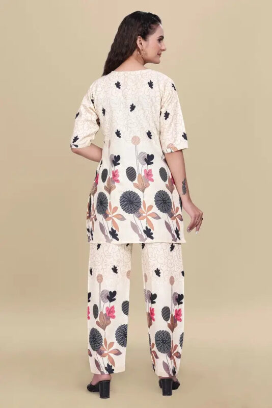 Woman wearing a floral kurta and palazzo set on a beige background