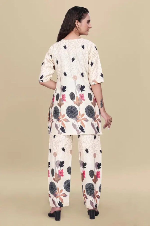 Woman wearing a floral kurta and palazzo set on a beige background